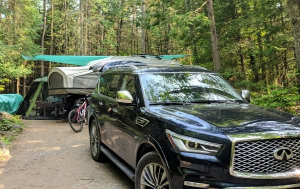 An INFINITI QX80 SUV parked in the camp site.