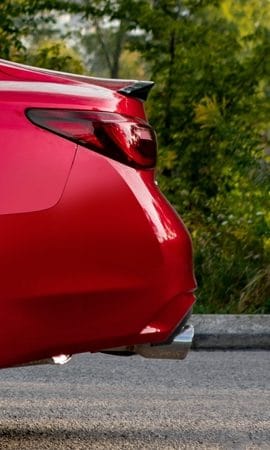 Mobile 428 x 926 wallpaper image of a red Q50 Sport Sedan's rear bumper.