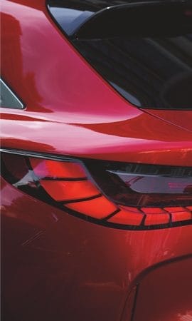 Mobile 428 x 926 wallpaper image of a red QX55 Crossover Coupe's back left headlight.
