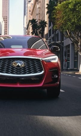Mobile 428 x 926 wallpaper image of a red QX55 Crossover Coupe's grill and front headlights.