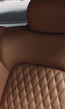 Mobile 428 x 926 wallpaper image of a QX80 Full-Size Luxury SUV's tan seat back upholstery.