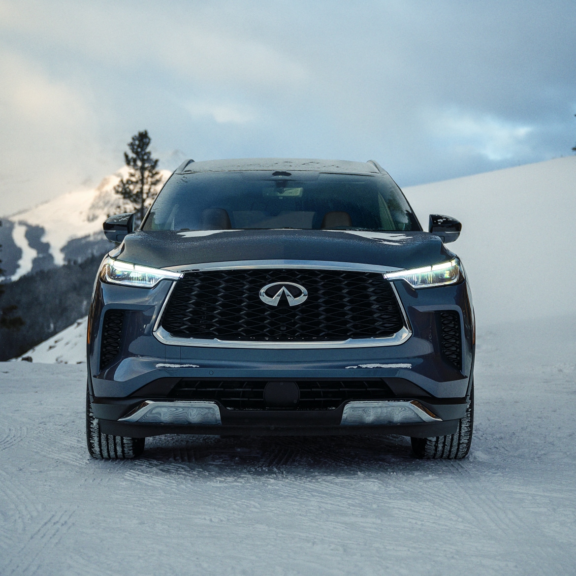 AWD INFINITI crossover driving off-road on snow