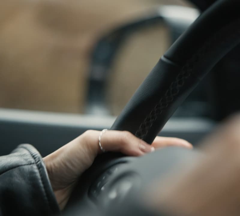 Close up of hand on INFINITI steering wheel 