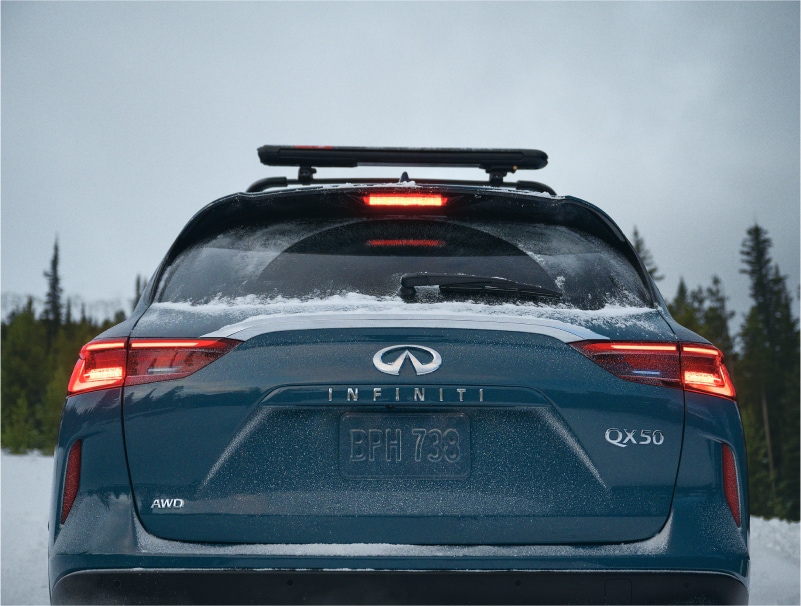 Rear view of INFINITI QX50 in snowy road conditions