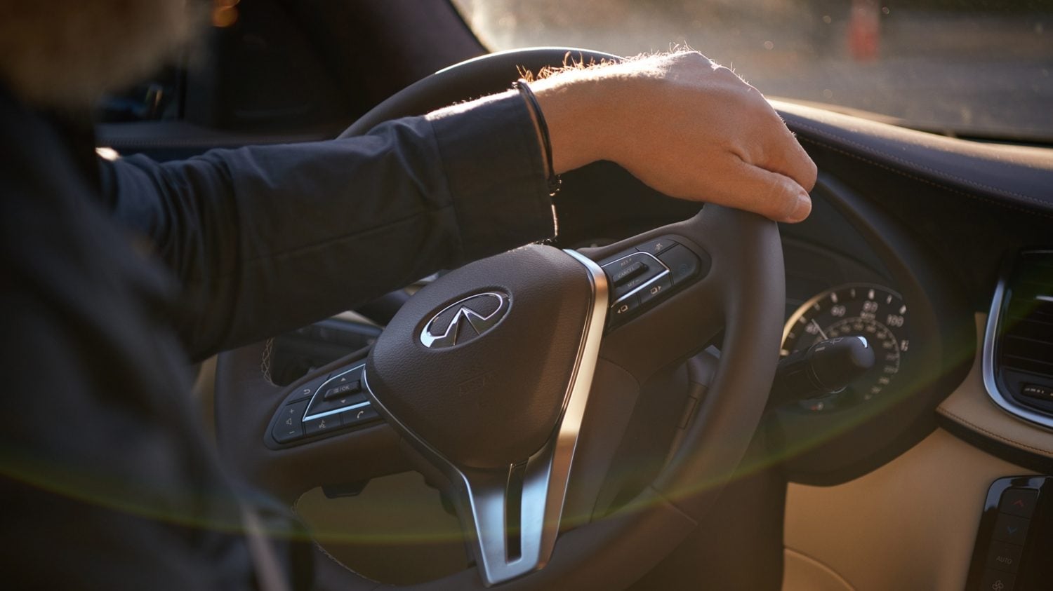 Interior View Of Man With Hand On INFINITI Steering Wheel