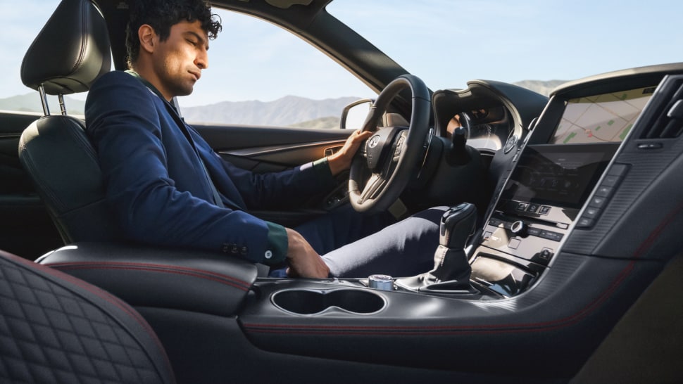 A man driving 2024 INFINITI Q50 luxury sedan