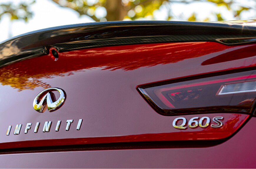 A red 2022 INFINITI Q60 S rear view showing tail light and spoiler
