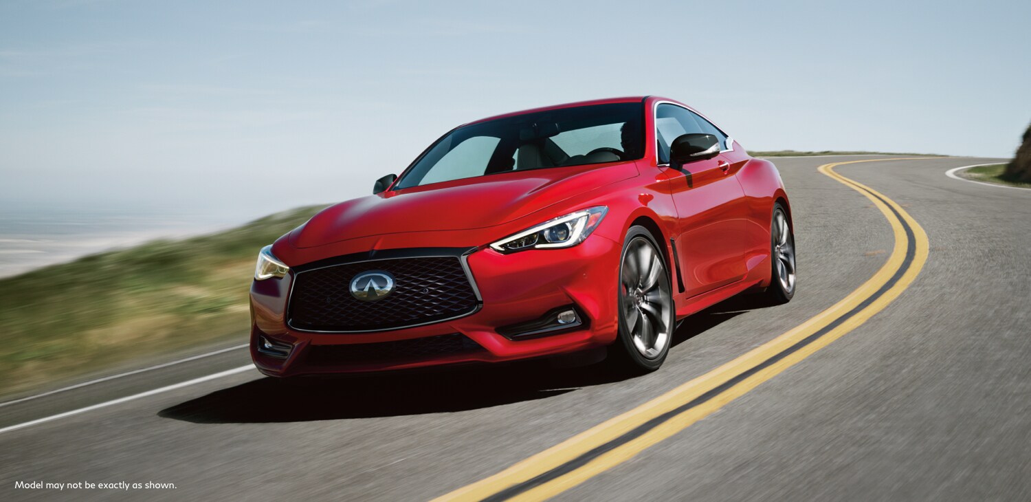 Front and side view of a 2022 INFINITI Q60 Red Sport i-line driving fast on the road