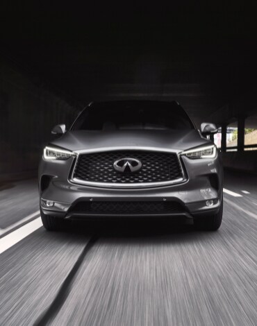 Front profile of a 2022 INFINITI QX50 highlighting its LED headlights and double-arch grille
