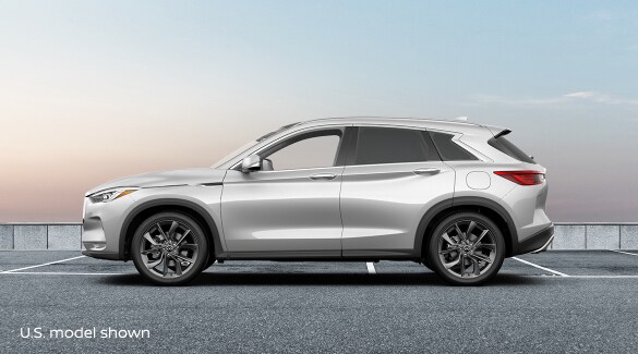 Side profile of a parked white 2023 INFINITI QX50 crossover