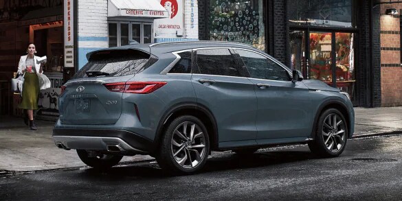 Rear and side profile of a blue 2023 INFINITI QX50