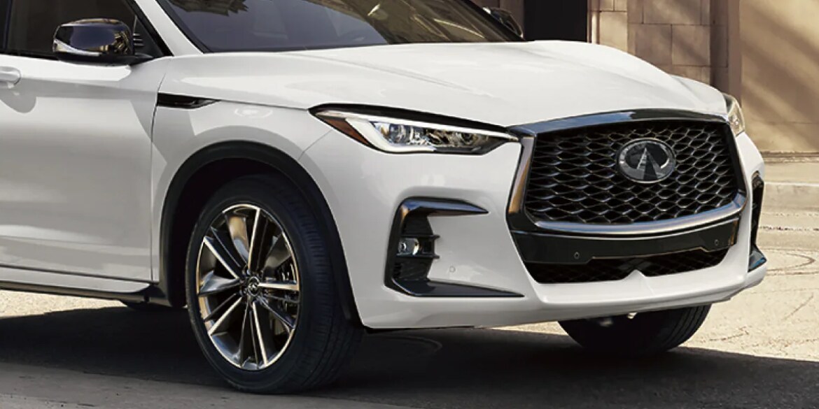 Front and side profile of a white 2023 INFINITI QX50 crossover