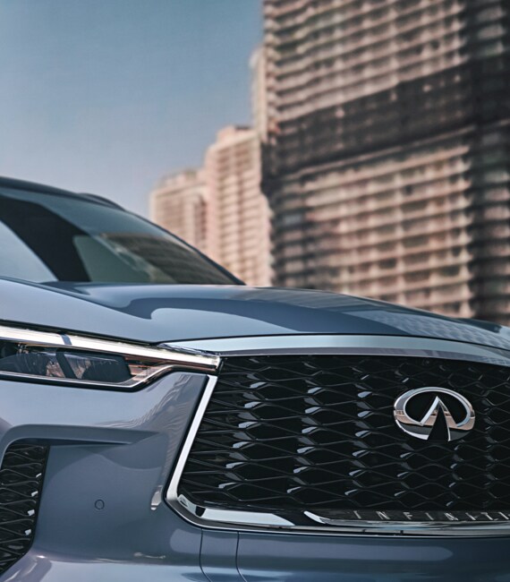 Close up view of 2022 INFINITI QX60 grille and LED headlight