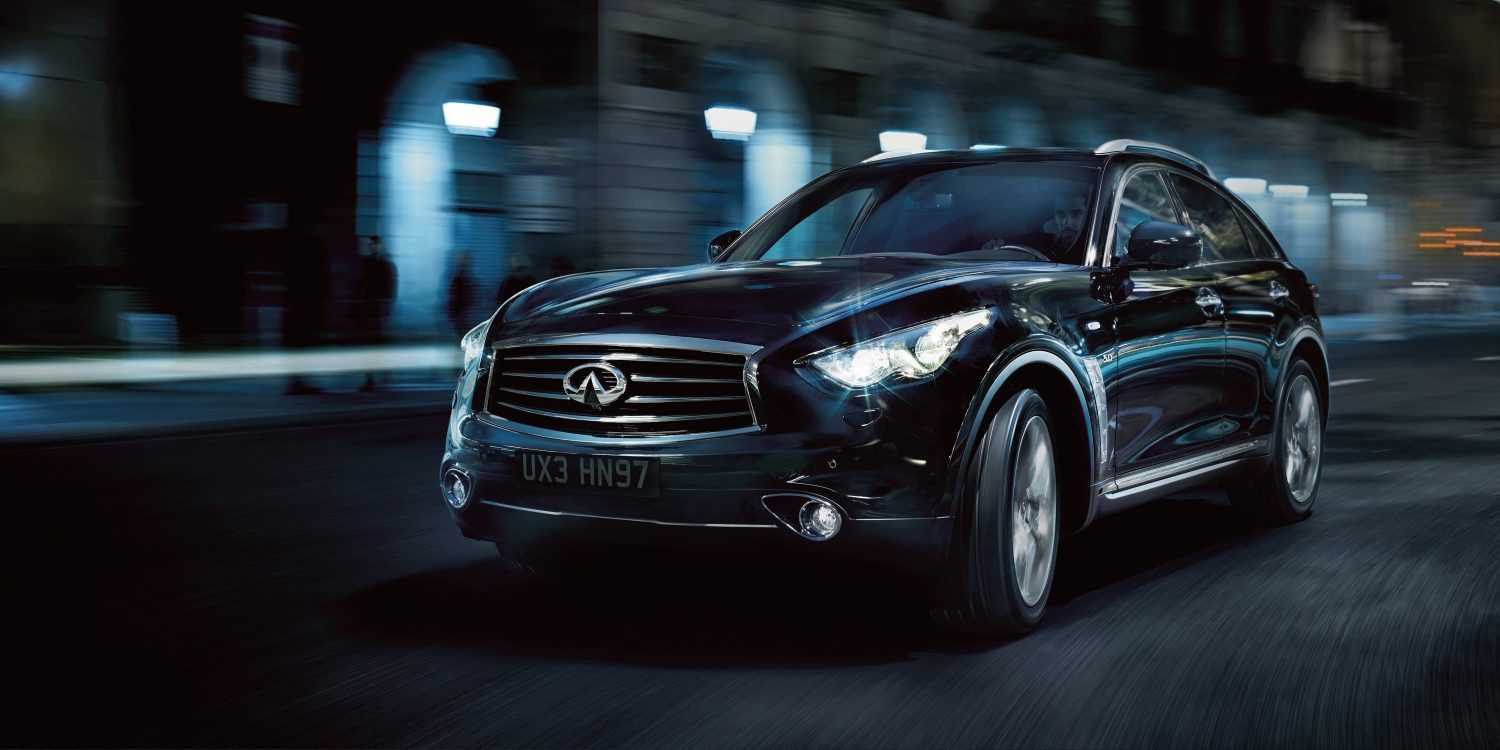Front profile of a black INFINITI FX35 driving at night