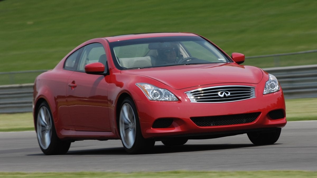 Front profile of a red INFINITI G37 driving fast on the track
