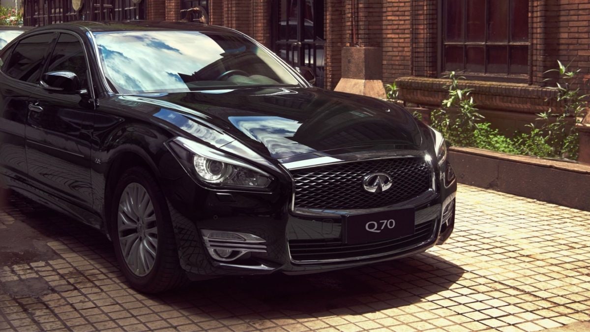 Front profile of a luxurious black INFINITI Q70 sedan with a black grille