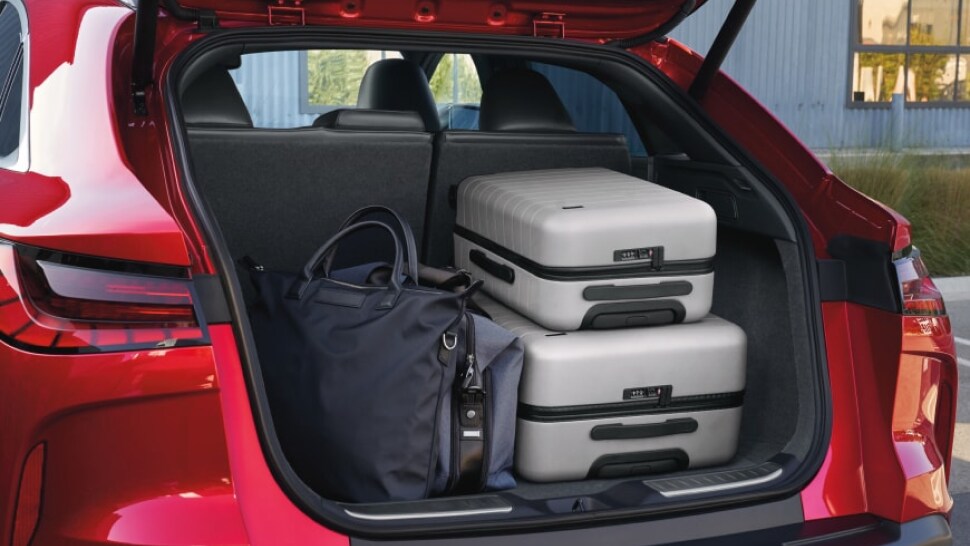 2023 INFINITI QX55 cargo space loaded with three pieces of luggage