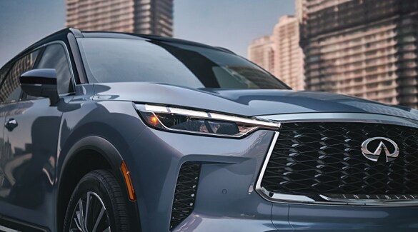Exterior close up of 2022 INFINITI QX60 Crossover SUV highlighting LED headlights, grille, and front fascia