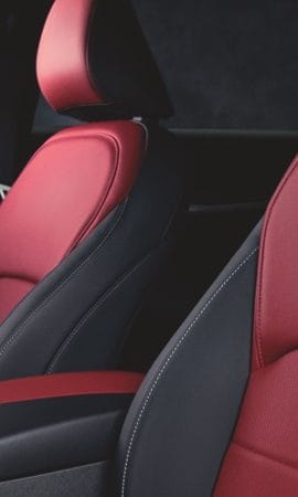 Mobile 428 x 926 wallpaper image of a red QX55 Crossover Coupe's interior front seats.