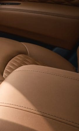 Mobile 428 x 926 wallpaper image of a QX80 Full-Size Luxury SUV's leather upholstery.