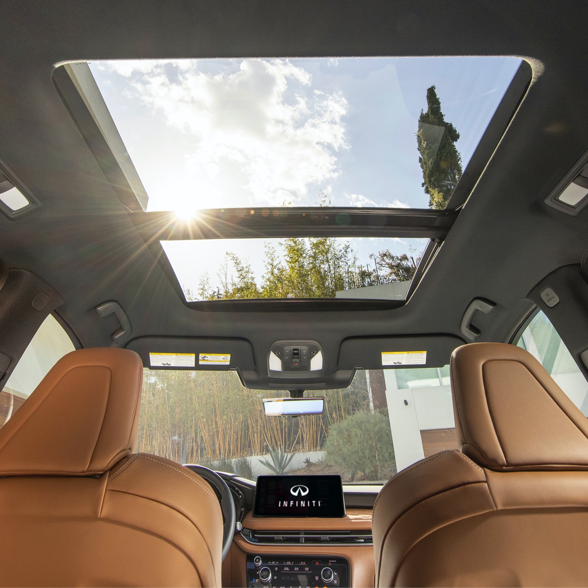 Looking out the sunroof inside an INFINITI QX60