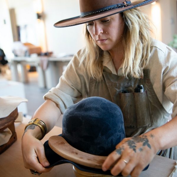 Keryn Nicholson from Keryn Nicholson Hat Company working on a blue hat.
