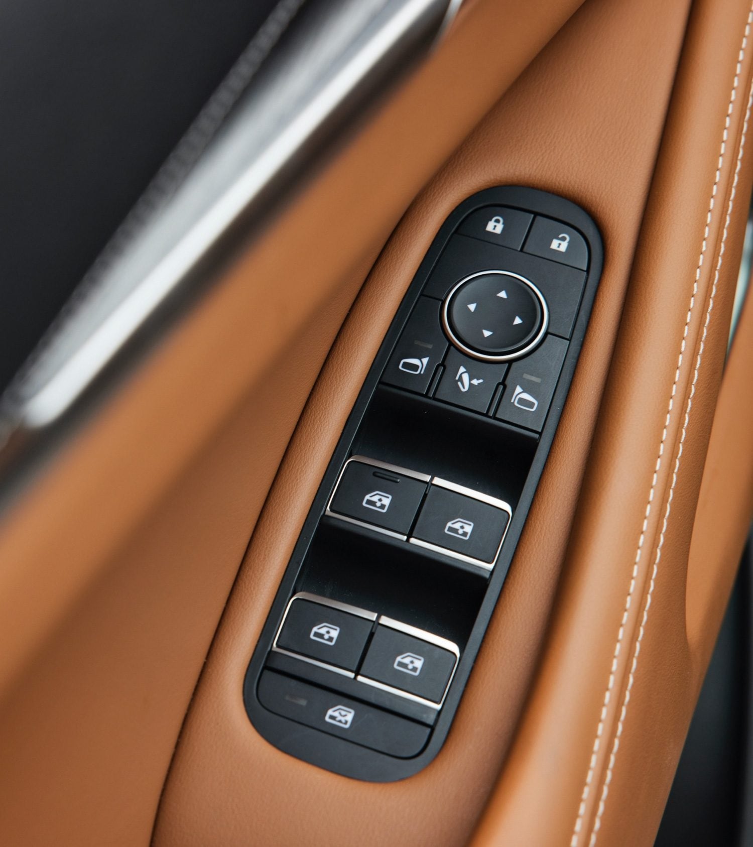 Power window buttons surrounded by luxurious brown leather in the 2022 INFINITI QX60 SUV